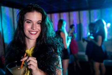 Portrait of young woman having a cocktail