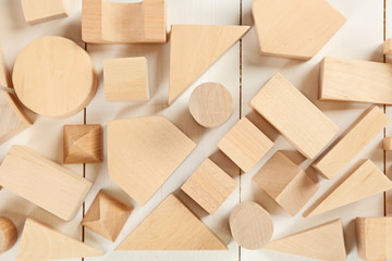 Wooden children's cubes on white wooden background