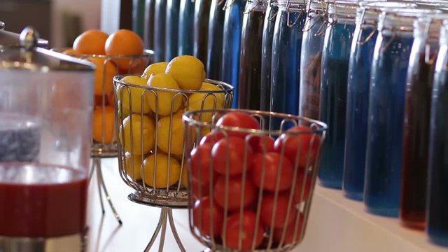 Interior design with colorful decorative glass bottles and fruits on tabletop