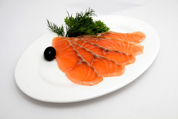 Slice of salmon on the plate on white background
