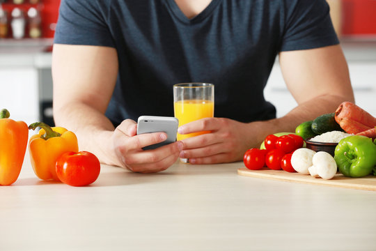 Man Counting Calories On Table