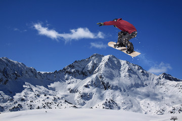 Naklejka na ściany i meble Snowboarder making high jump in cloudy sky.