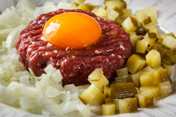 Steak tartare with egg yolk, onions and pickles