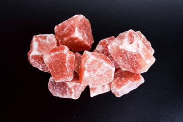 Himalayan pink crystal salt on dark background