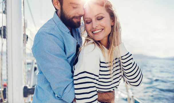 Affectionate young couple standing on boat