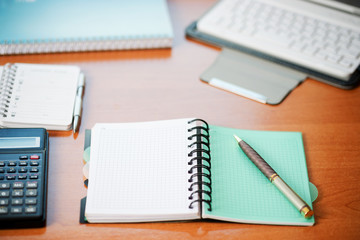 Office desk table with computer, calculator, supplies. Copy space for text