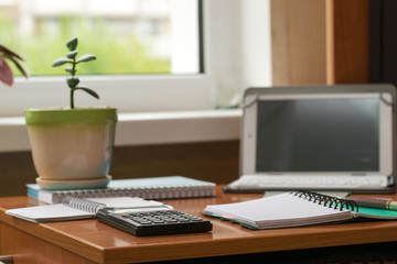 Office desk table with computer, supplies, flower. Copy space for text