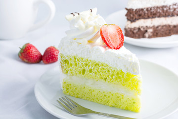 Close up Japanese Matcha Green tea cake decorated with strawberr