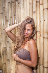 Fototapeta premium Woman at the bamboo wall