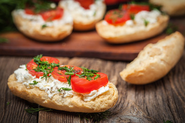 Delicious bruschetta with tomatoes, feta cheese, dill and spice