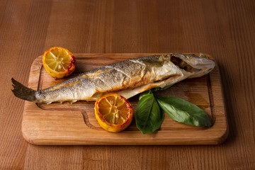 Grilled seabass on the wooden board