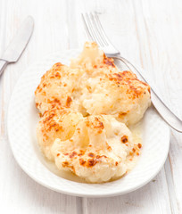 cauliflower cooked in white tray on wooden
