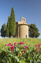 view to old chapel with wheat field in Tuscany in Italy