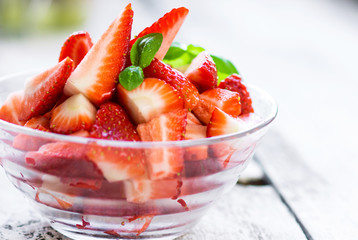 Delicious slices of organic strawberries in a cup