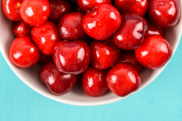White Bowl Of Fresh Red Cherries On Turquoise Background