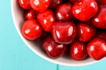White Bowl Of Fresh Red Cherries On Turquoise Background