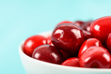 White Bowl Of Fresh Red Cherries On Turquoise Background