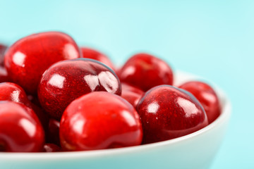 White Bowl Of Fresh Red Cherries On Turquoise Background