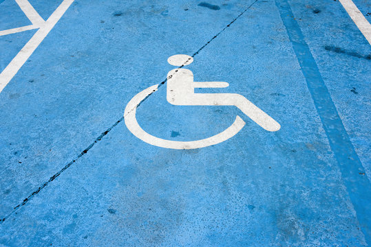 Handicapped Parking Sign On The Cement Floor