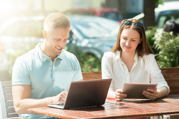 Couple With Digital Tablet And Laptop