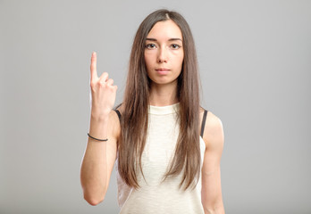 Woman showing her index finger up