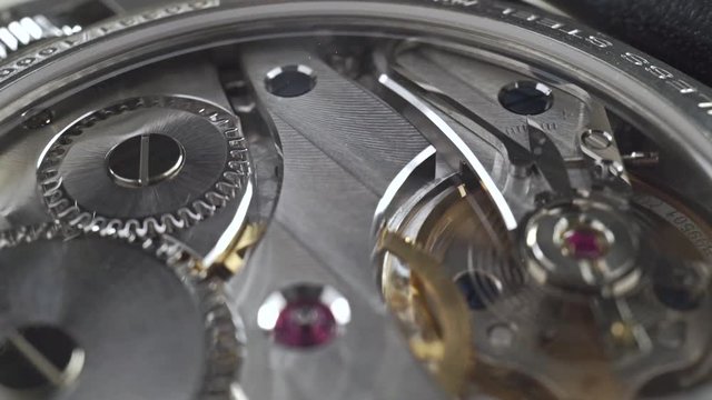Luxury wrist watch movement in action, macro video