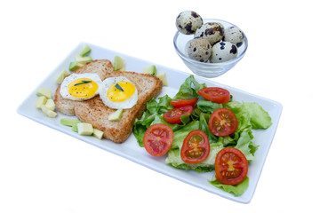 Toast with quail eggs and salad on a white background