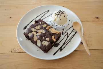 brownies almond with ice cream vanilla on white dish.