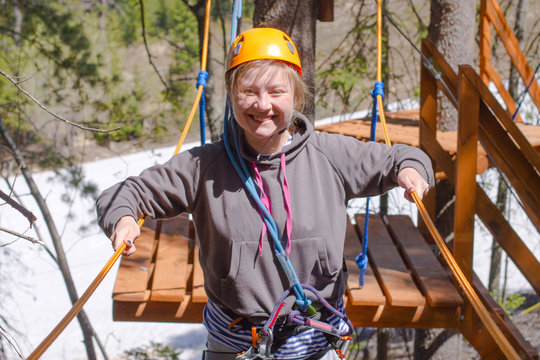 girl climbs into ropes course