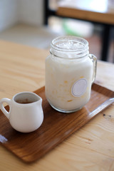 Pouring cocoa syrup on glass mug, iced cocoa menu.