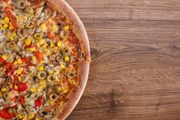 Vegetarian pizza on rustic wooden background, fast food, copy space for text
