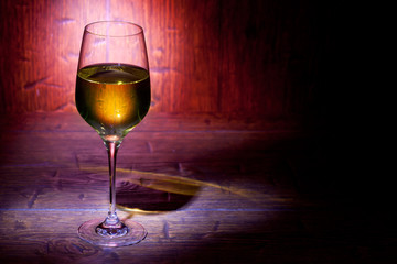 Wine glass on red wooden background