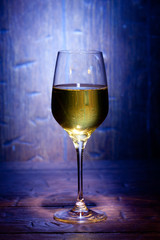 Wine glass on blue wooden background