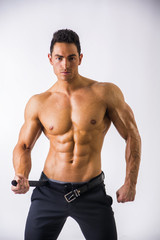Handsome shirtless muscular man with elegant pants
