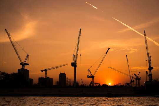shillouette contruction and cranes beside the Rive