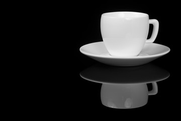White cup on glossy black background
