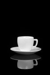 White cup on glossy black background