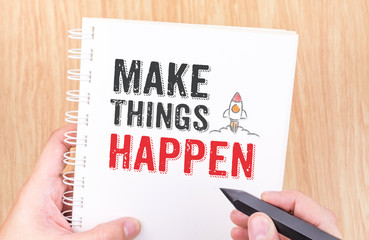 Make things happen word on white ring binder notebook with hand