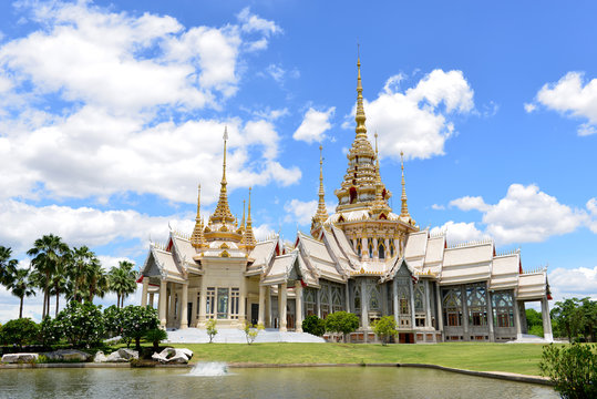 Beautiful Thai sculpture temple and and Blue sky with Clouds background.