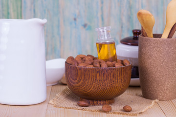 almond oil and  almonds seed on wooden background