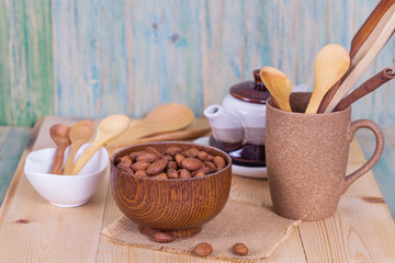 Fototapeta na wymiar Almonds in brown bowl on textured wooden background