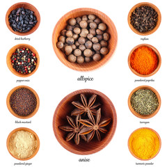 Large collection of different spices and herbs in wooden bowls, isolated on white background