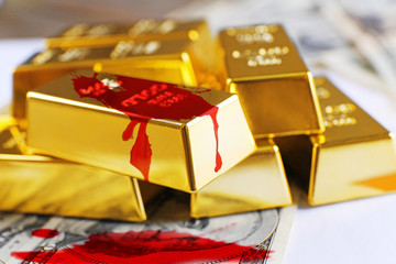 Gold bars with dollar banknotes and blood splashes