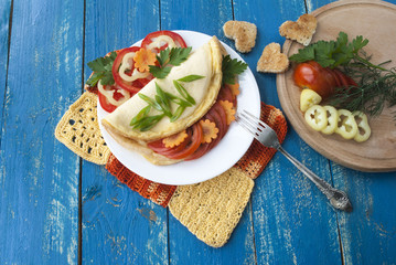 omelette with fresh vegetables, tasty and healthy food, tomatoes and pepper