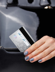 Closeup of a woman hand and a credit card