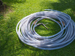 Rubber tube on green grass field.