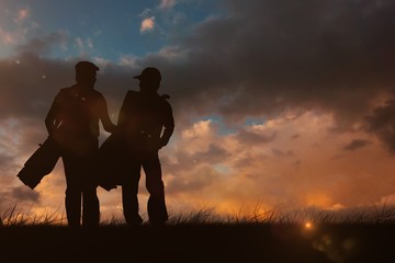 Fototapeta premium Composite image of men carrying golf equipment