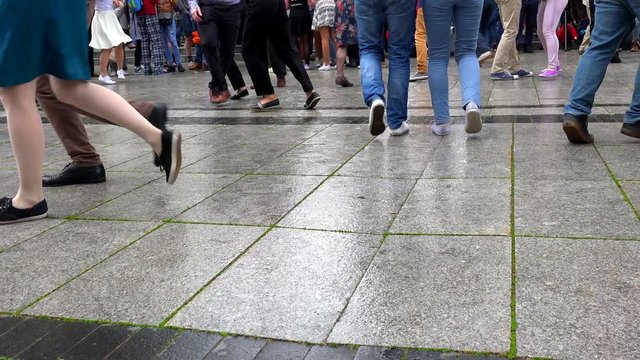 street dancers legs perform lindyhop dance on street music day.