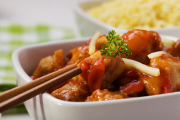 Fried chicken pieces in batter with sweet and sour sauce