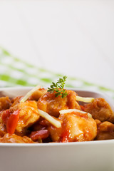 Fried chicken pieces in batter with sweet and sour sauce